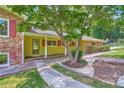 Ranch home with brick accents, red shutters, a walkway, and mature landscaping at 5401 Smoke Rise Dr, Smoke Rise, GA 30087