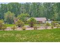 Brick and siding house surrounded by lush greenery and a well-maintained lawn at 5401 Smoke Rise Dr, Smoke Rise, GA 30087