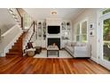 Warm living room boasting hardwood floors, a fireplace, built-in bookshelves, and lots of natural light at 1126 Francis Ne St, Atlanta, GA 30319