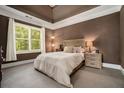 Serene bedroom featuring neutral carpet, a large window and an elegant trey ceiling at 1126 Francis Ne St, Atlanta, GA 30319