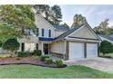 Charming two-story home with well-maintained landscaping and a two-car garage in a suburban neighborhood at 1171 Pine Acre Dr, Sugar Hill, GA 30518