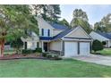 Charming two-story home with well-maintained landscaping and a two-car garage in a suburban neighborhood at 1171 Pine Acre Dr, Sugar Hill, GA 30518