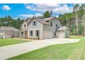 Two-story home showcasing an attached two-car garage and an extra garage on the side at 600 Sidney Ct, Stockbridge, GA 30281