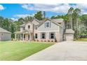 Stylish two-story home with attached garages, a blend of brick and siding, and manicured lawn at 600 Sidney Ct, Stockbridge, GA 30281