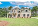 Charming two-story home with a mix of brick and siding, featuring a well-kept lawn at 600 Sidney Ct, Stockbridge, GA 30281