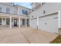 Exterior featuring two-car garage, covered porch, and beautiful architectural details at 1005 Coleman Place Dr, Roswell, GA 30075