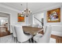 Formal dining room with stylish chandelier and classic wainscoting at 4004 Charrwood Trce, Marietta, GA 30062