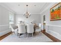 Formal dining room with stylish chandelier and classic wainscoting at 4004 Charrwood Trce, Marietta, GA 30062