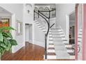 Elegant foyer with hardwood floors, staircase, and decorative millwork at 4004 Charrwood Trce, Marietta, GA 30062