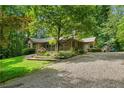 View of the landscaped front yard, gravel driveway, and charming exterior of the home at 1920 Jett Ridge Rd, Cumming, GA 30041