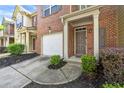 Attractive townhouse with attached garage, well-manicured landscaping, and inviting entryway at 3379 Thornbridge Dr, Powder Springs, GA 30127