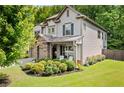 Beautiful home exterior showcasing manicured landscaping, stone accents, and a well-maintained lawn at 4779 Bogan Meadows Dr, Buford, GA 30519