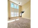 Spacious living room with large windows and soaring ceilings at 6005 Pattingham Dr, Roswell, GA 30075