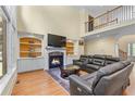 Cozy living room boasts a fireplace, built-in shelves, and a comfortable leather sectional at 1085 Highland Crest Ct, Mableton, GA 30126