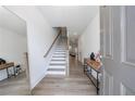 Bright entryway featuring wood-look floors, staircase with white risers, and stylish decor at 1624 Gunnin Nw Trce, Atlanta, GA 30318