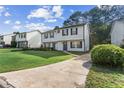 Pleasant townhome with a well-kept lawn and a concrete driveway at 3589 Hopkins Ct, Powder Springs, GA 30127