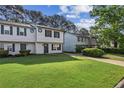 Attractive townhome showcasing a lush green lawn and a paved driveway at 3589 Hopkins Ct, Powder Springs, GA 30127