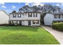 Inviting two-story townhome featuring a well-manicured lawn and a private driveway at 3589 Hopkins Ct, Powder Springs, GA 30127