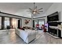 Bright living room with a vaulted ceiling, fireplace, and a large ceiling fan, perfect for relaxation at 2190 Ashley Crossing Ct, Lawrenceville, GA 30043