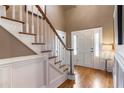 Bright foyer with a hardwood floor, staircase with white railings, and an entry door with sidelights at 567 N Palisades Se Cir, Marietta, GA 30067