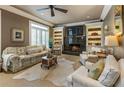 Comfortable living room with a fireplace, built in shelves, and abundant natural light at 567 N Palisades Se Cir, Marietta, GA 30067