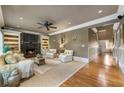 Cozy living room features hardwood floors, a fireplace with built-in shelving, and comfortable seating arrangement at 567 N Palisades Se Cir, Marietta, GA 30067