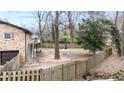Secluded backyard with a wooden fence, mature trees, and potential for outdoor entertainment at 1343 Renee Dr, Decatur, GA 30035