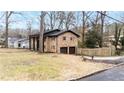 Brick home exterior showcases an attached two-car garage and manicured lawn, highlighting its curb appeal at 1343 Renee Dr, Decatur, GA 30035
