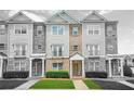 Charming multi-story townhouse with stone and siding exterior, complemented by well-manicured landscaping at 5529 Festival Ave, Fairburn, GA 30213