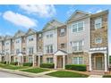 Attractive townhome exterior featuring stone accents, siding, and well-maintained front yard landscaping at 5529 Festival Ave, Fairburn, GA 30213