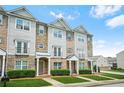 Attractive townhome exterior featuring stone accents, siding, and well-maintained front yard landscaping at 5529 Festival Ave, Fairburn, GA 30213