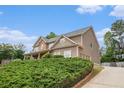Two-story home with covered porch, attached garage, and well-maintained landscaping at 6086 Willowpond Ct, Douglasville, GA 30135