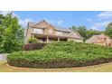 Beautiful two-story home with stone and siding, a welcoming front porch, and lush, mature landscaping at 6086 Willowpond Ct, Douglasville, GA 30135