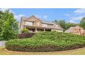 Beautiful two-story home with stone accents, covered porch, and mature landscaping at 6086 Willowpond Ct, Douglasville, GA 30135
