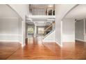 Elegant foyer with gleaming hardwood floors, wainscoting, and an open staircase at 6086 Willowpond Ct, Douglasville, GA 30135