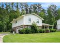 Two-story home with a well-maintained lawn and a driveway leading to an attached garage at 757 Tall Deer Dr, Fairburn, GA 30213
