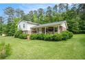 Home with a inviting covered porch and lush green landscaping, creating great curb appeal at 757 Tall Deer Dr, Fairburn, GA 30213