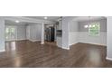 Open-concept living area with stylish flooring and a seamless flow to the kitchen at 856 Bridgewater Sw St, Atlanta, GA 30310