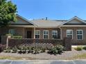 Inviting brick townhome featuring a decorative brick privacy wall and well-maintained yard at 125 Villa Park Cir, Stone Mountain, GA 30087