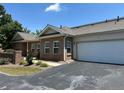 Attractive single-story brick townhome with an attached garage, showcasing its curb appeal at 125 Villa Park Cir, Stone Mountain, GA 30087