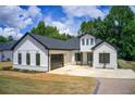 Charming white home boasts a convenient garage and well-kept landscaping at 532 Rockbridge Rd, Lilburn, GA 30047