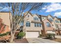 Inviting townhouse with a two-car garage, a combination of brick and siding, and a neatly manicured front yard at 506 Glen Ivy # 5, Marietta, GA 30062