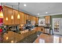 Open kitchen features wood cabinets, granite countertops, stainless appliances, and hardwood flooring at 506 Glen Ivy # 5, Marietta, GA 30062