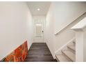 Modern entryway with stylish wood floors, white walls, and staircase with carpeted steps at 668 Isom Walk, Suwanee, GA 30024