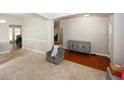 Spacious living room showcasing a chair, carpet, an archway to the front entrance and access to other rooms at 1000 Willow Crest Lndg, Austell, GA 30168