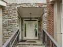 Townhome entrance detailed with stone, brick, and a traditional white door with glass accents at 3066 Quantum Ln # 24, Atlanta, GA 30341
