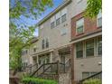 Exterior view of townhomes with stone and brick accents, showing stairs to covered front entries at 3066 Quantum Ln # 24, Atlanta, GA 30341
