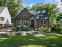 Brick house featuring a stone-accented doorway, charming pergola, and a well-manicured lawn and garden at 978 Eden Se Ave, Atlanta, GA 30316