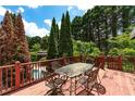 Outdoor deck with dining set, perfect for al fresco meals and entertaining guests with a view at 11569 Finley St, Suwanee, GA 30024