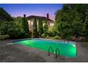 Inviting backyard pool with lush greenery, creating a private oasis for relaxation and recreation at 11569 Finley St, Suwanee, GA 30024